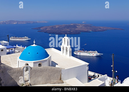 a white church with a blue dome in front of the blue Aegean Sea, Fira, Santorini Island, Cyclades, Aegean Islands, Greece Stock Photo