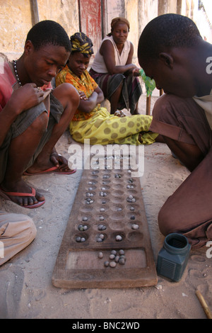 Mozambicans playing traditional board game in the street, Ilha de Mozambique. Stock Photo