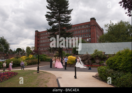 A wedding being photographed near Belper North Mill, River Gardens, Belpher, Derbyshire Stock Photo