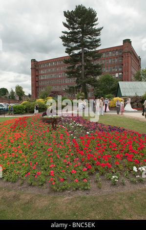 A wedding being photographed near Belper North Mill, River Gardens, Belpher, Derbyshire Stock Photo