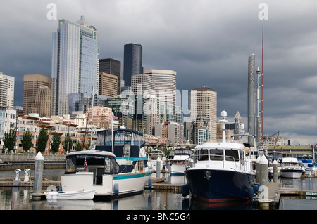 View of boats in the Bell Harbor Marina with the Seattle, Washington skyline in the background. Stock Photo
