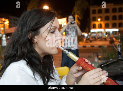 Egypt tourist; a woman smoking Shisha pipe; or hookah pipe,  Aswan, Upper Egypt  Africa Stock Photo