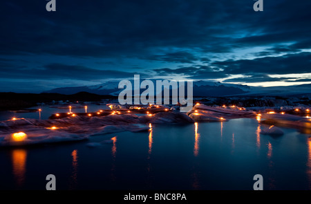 Candles lit on icebergs for a celebration at The Jokulsarlon Glacial Lagoon,  Iceland Stock Photo