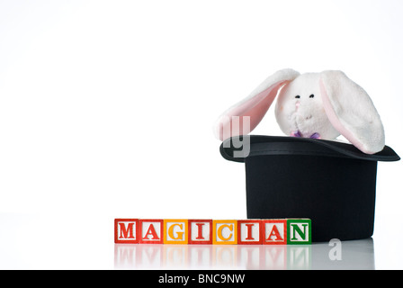 Colorful children's blocks spelling MAGICIAN with a bunny rabbit in a top hat Stock Photo
