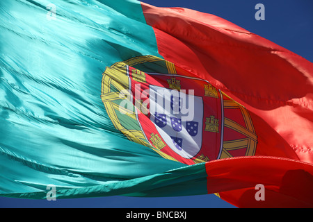 Portuguese Flag against blue sky Stock Photo