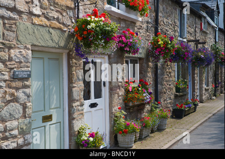 Picturesque row of terraced cottages with hanging baskets outside in Hay-on-Wye Powys Wales UK Stock Photo