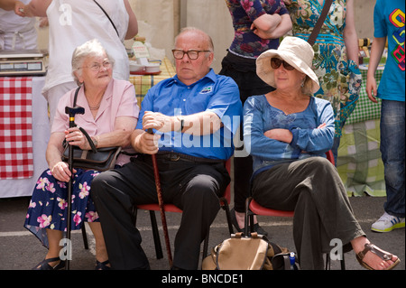 Senior people relaxing and enjoying the Hay Food Festival in the market square in Hay-on-Wye Powys Wales UK Stock Photo