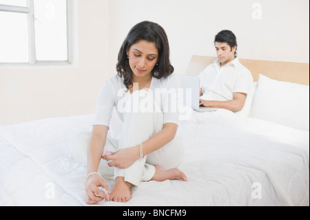 Woman painting her toenails Stock Photo