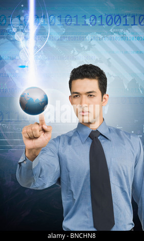 Businessman touching a globe Stock Photo