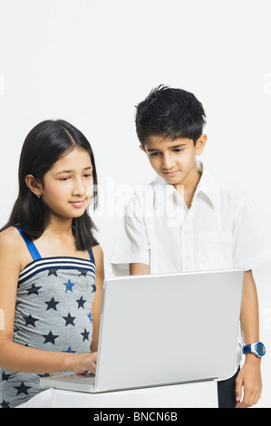 Girl and a boy working on a laptop Stock Photo