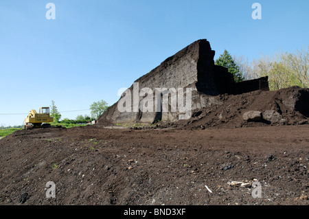 Stockpile of peat at the site of a cutting operation taking place on the Somerset levels in Britain Stock Photo