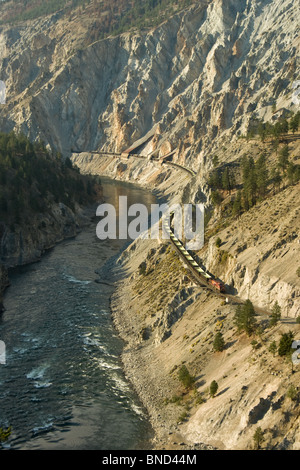 A train winds it's way through the Fraser Canyon north of Lytton, BC Canada. Stock Photo