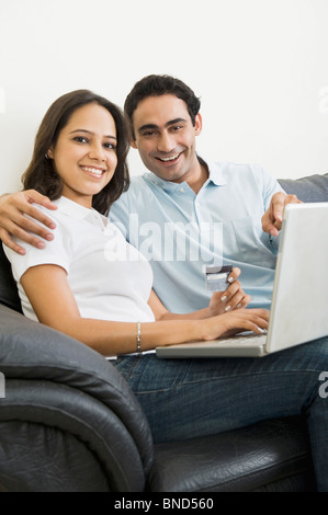 Couple doing online shopping with a laptop Stock Photo