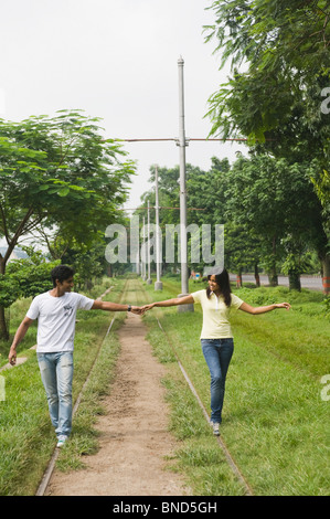 Couple walking on railroad tracks, Kolkata, West Bengal, India Stock Photo