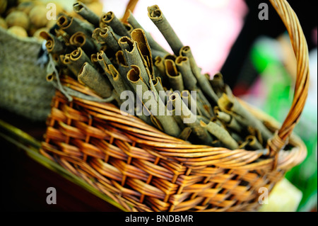 Cinnamon sticks in a basket in spice shop Stock Photo