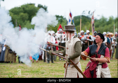 Medieval male gunner firing a handgonne on the battlefield at the Tewkesbury medieval festival 2010. Gloucestershire England Stock Photo