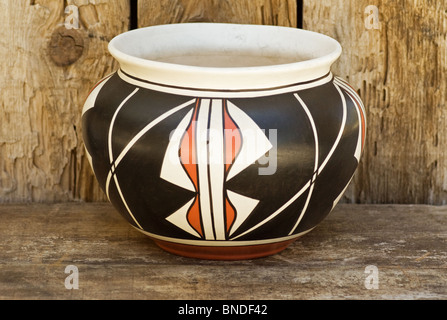 Contemporary Native American Indian clay pot pottery on old wood shelf. Stock Photo