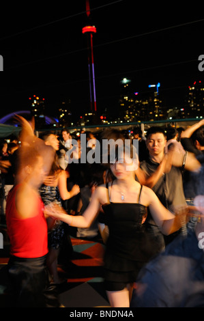Young people latin dancing on a nightclub boat cruise with Toronto skyline Stock Photo