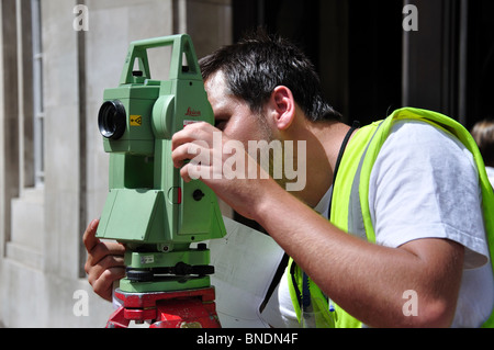 Male surveyor working with automatic level, Regent Street, City of Westminster, London, England, United Kingdom Stock Photo