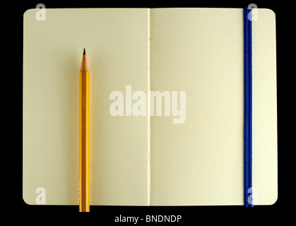 Classic opened moleskine note book with pencil isolated on black background Stock Photo