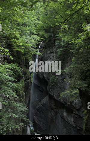 Beautiful scenic Misty soft focus waterfall and fast flowing river in natural attraction Partnach gorge Garmisch-Partenkirchen Bavaria Germany Stock Photo