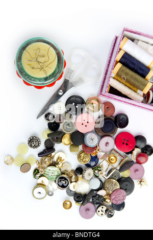 sewing stuff buttons nails thread scissors mixed still life on white Stock Photo