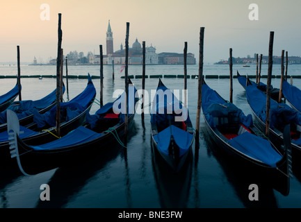 Moored gondolas at dawn on the grand canal in Venice Italy Stock Photo