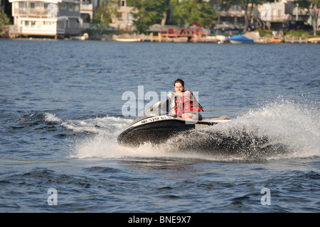 Guy riding a Sea Doo jet ski on Lake Sunapee in New Hampshire. Stock Photo