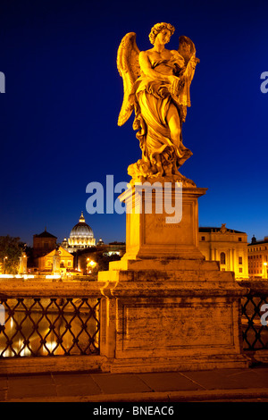 Angel on Ponte Sant Angelo with St. Peter's Basilica beyond at dusk, Rome Lazio Italy Stock Photo