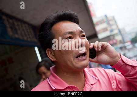 Chinese man talking on a mobile phone in Guilin, Guangxi Province, China Stock Photo
