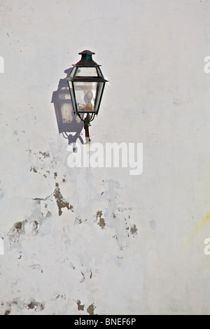 Black Metal Lantern with a Strong Shadow located in a Medieval Village in Europe Stock Photo