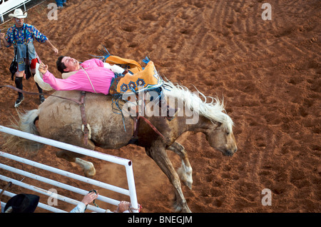 Rodeo member of PRCA loosing balance on horse in Smalltown Bridgeport, Texas, USA Stock Photo