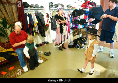 Tourist family getting ready in western style at Wildwest clothing for photo shoot in Galveston, USA Stock Photo