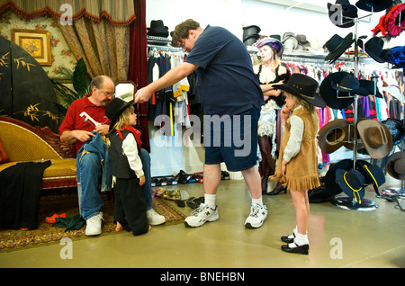 Tourist family getting ready in western style clothing at Wildwest for photo Shoot in Galveston, USA Stock Photo