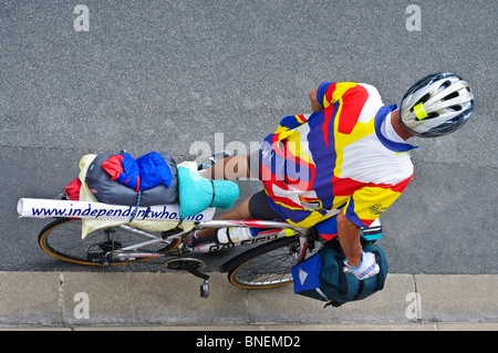 Touring cyclist waiting at kerb - France. Stock Photo