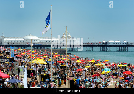 Brighton beach crowded with tourists on a hot summers day Stock Photo