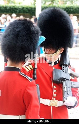 Commanding officer adjusting bearskin of trooper / guardsman on The Mall Trooping the Colour June 2010 London England UK Stock Photo