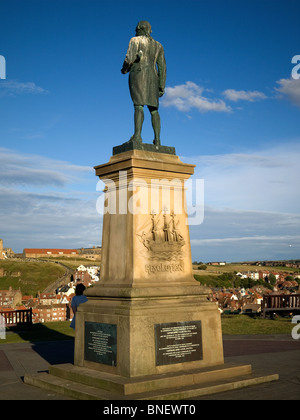 Commemorative statue of famous explorer Captain James Cook overlooking Whitby Harbour Stock Photo