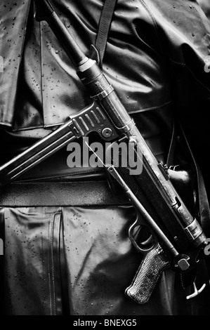WW2 German army soldier carrying MP40 9 mm submachine gun. Historical re enactment. Monochrome Stock Photo