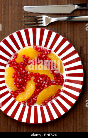 Freshly Prepared Healthy Fresh Pomegranate and Orange Salad After Dinner Dessert Served on A Plate With No People As A Flat Lay Close Up Stock Photo