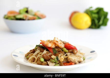 Authentic Thailand Style Street Food Stir-Fried Pad Thai Noodles With Chicken And Prawns Against A White Background With No People Stock Photo
