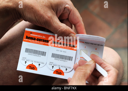 Man using bowel cancer screening test England UK NHS screening test testing kit kits Stock Photo