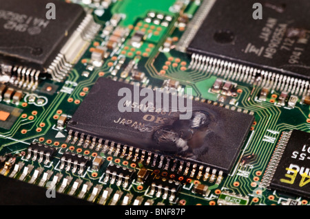 Electronic integrated circuit (IC) on a computer PCB after suffering a catastrophic static discharge and burn out Stock Photo