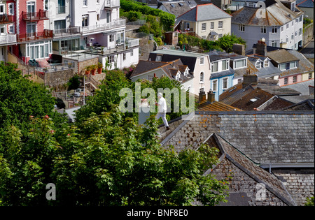 Chimney repair, Salcombe, South Hams, Devon. The repairman has a wonderful view over the roofs of the town. Stock Photo