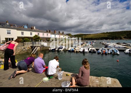 Tourists crabbing on a dock in Salcombe, South Hams, Devon. Stock Photo