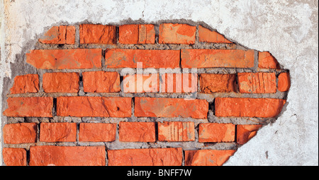 The big damage of a brick wall - an industrial urbanistic background Stock Photo