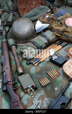 WW2 German army soldiers equipment including hand grenade, rifle, bullets, helmet and a pistol Stock Photo