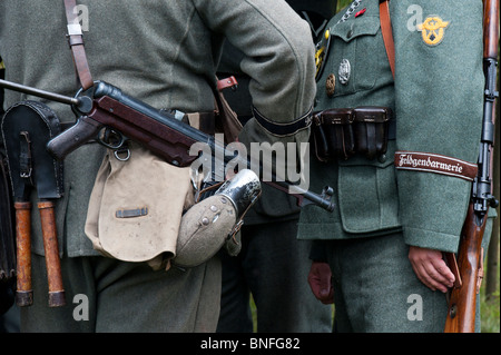WW2 German army soldier with officer carrying MP40 9 mm submachine gun. Historical re enactment. Stock Photo