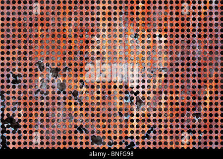 A damaged rusty steel sheet with holes worn-out Stock Photo