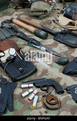 WW2 German army soldiers equipment including stick grenade, knife, flare gun, shovel, hand grenade and compass and a map case Stock Photo